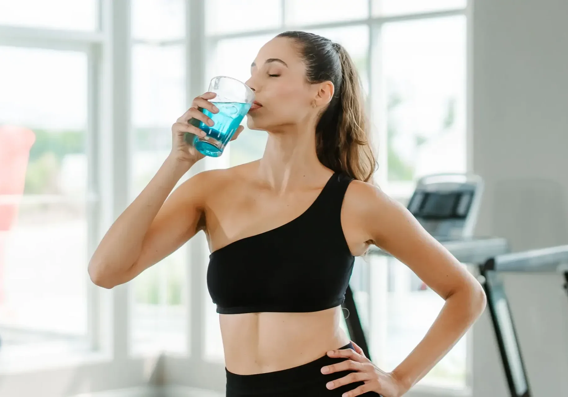 a-woman-is-drinking-a-blue-drink